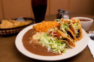A plate of delicious mexican style street tacos and beans in Odessa, TX